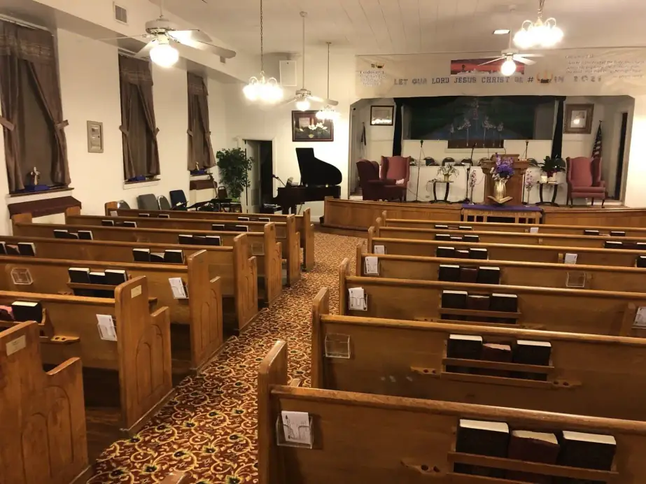 Pews, the piano and the platform seen from the side of the sanctuary